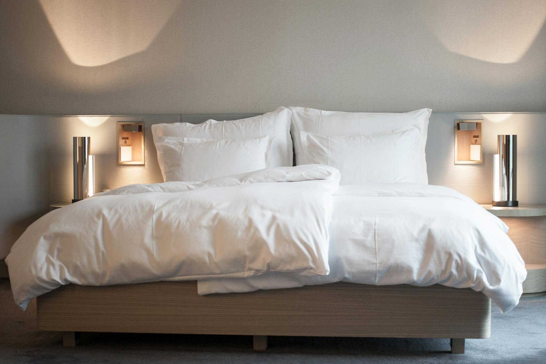 Minimalist guest bedroom with natural light and premium bedding